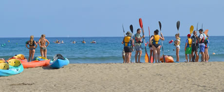 youth canoeing on beach